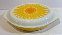 Top view showing sunflower graphic on white surface of divided dish