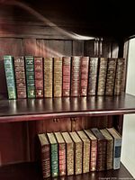 Two shelves holding 23 Reader's Digest Condensed hardcover books