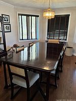 Overall view of cherry dining table with chairs around it