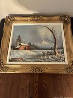 Front view of framed oil painting showing full winter scene