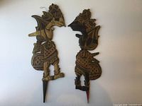Full view of both wooden shadow puppets showing size and form