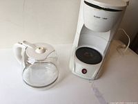 Full view of coffee maker and separate glass carafe