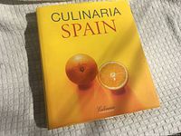 Front cover of Culinaria Spain hardcover with yellow dust jacket and orange imagery