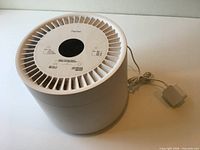 Top angled view of white Petree cylindrical air purifier with power cord