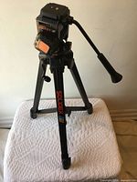 Tripod mid-height showing legs and head, brand visible