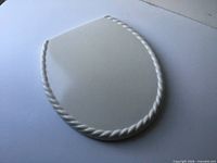 Top view showing white wood lid with rope-style beveled edge