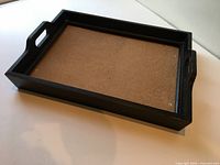 Oblique view showing tray interior, handles, and removable bottom panel