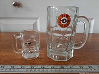 Large and small A&W Root Beer glass mugs side by side