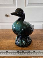 Front angled view of ceramic duck on ruler for scale