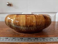 Side profile showing full exterior drip glaze and height reference with ruler