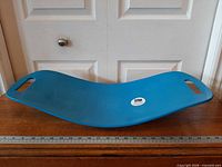 Full view of blue Simply Fit Board showing concave shape and handholds