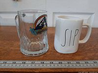 Front view of both drinking vessels beside ruler for scale