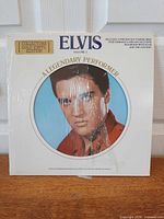Front cover showing circular Elvis portrait and Collectors Gold Vinyl Edition sticker