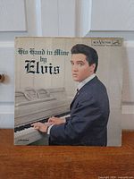 Front cover of Elvis Presley "His Hand in Mine" LP showing title, artist, piano image, RCA Victor logo, catalog number