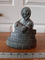 Front view showing full Inuit figure and igloo wall with ruler for scale