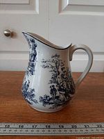 Full left profile of pitcher with ruler for scale