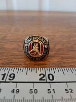 Front view of ring showing top design with enamel insert and text