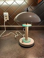 Full view of lamp showing dome shade, base, cord