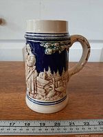 Full view of stein front side with tavern scene