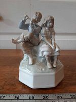 Front view of Otagiri porcelain music box showing boy playing flute to girl