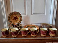 Front view showing mugs and stacked plates