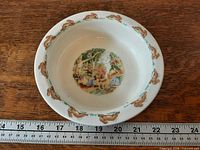 Top view of bowl showing rabbit border and ruler for scale