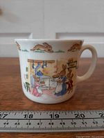 Front view of mug showing Bunnykins baking scene