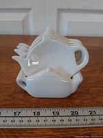 Stacked tea bag holders in caddy front view with ruler for scale