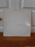 Front of white gatefold sleeve with embossed The BEATLES