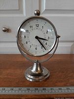 Front angled view of exposure timer on stand with ruler for scale