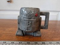 Front view of gray sculpted R2-D2 mug