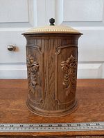 Front view showing faux wood grain body and raised scroll design