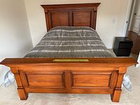 Front view showing headboard, footboard, mattress and comforter