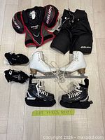 All items laid out: CCM skates, figure skates, gloves, shoulder pads, pants