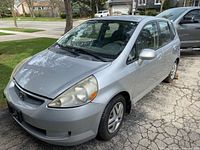 Driver front quarter view of silver 2007 Honda Fit showing overall body condition
