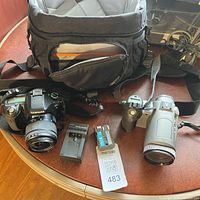 Overall lot showing Samsung DSLR, Canon camcorder, charger, batteries, and camera bag