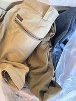 Khaki Patagonia shorts and additional clothing in bag