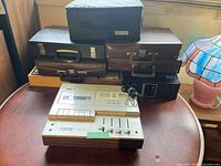 Front view showing AGS Audio Reflex cassette player and six cassette cases