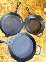 Top view of all three cast iron pans showing sizes and handle styles