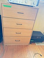 Front view of dresser showing four drawers and handles