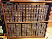 Full view of two shelves showing complete encyclopedia set volumes 1-30 and yearbooks