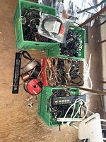 overview of three crates with cords, power strips, wire spools