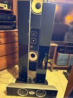 Front view of two CST55 tower speakers with matching center channel speaker