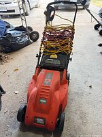 Front view of Black & Decker corded lawn mower, cords coiled on handle