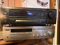 Front view of both receivers stacked, showing model numbers and controls