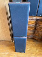 Front view of both Polk Audio speakers stacked showing full grills