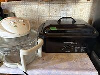 Hamilton Beach roaster oven and FlavorWave Turbo Mini oven side by side on countertop