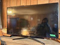 Front view of Samsung 40-inch TV on stand with screen and bezel visible