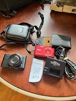 Overview of cameras, charger, cord, and cases