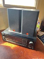 Sony STR-D2020 receiver with two JBL speakers stacked on top